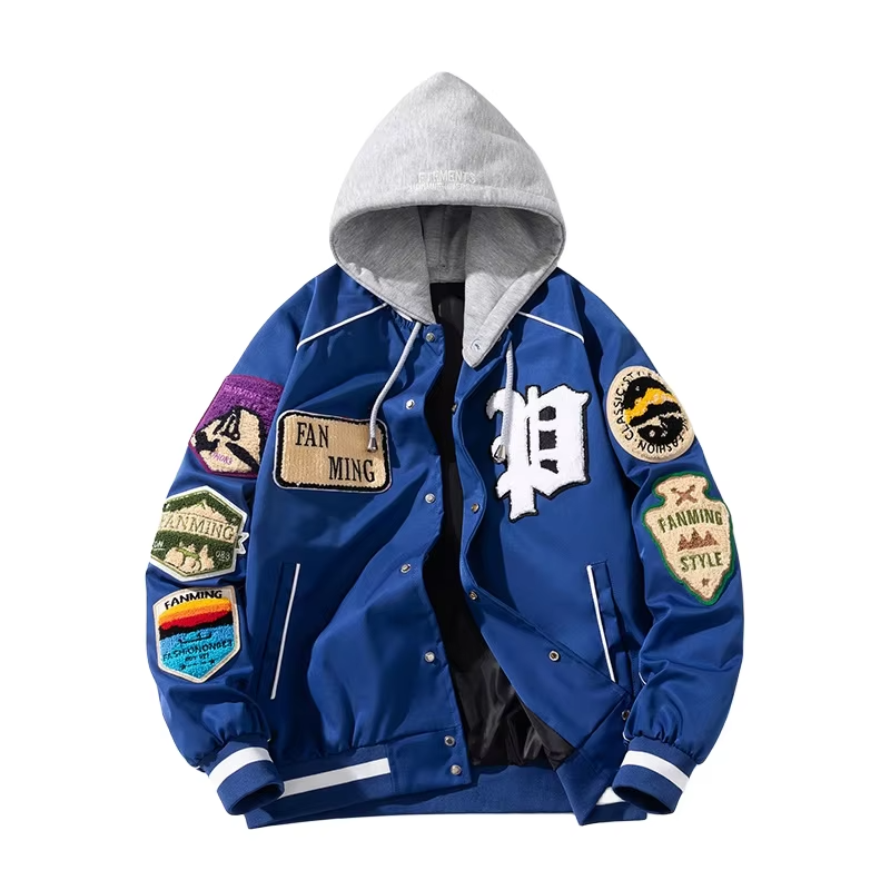 A detailed view of a custom badge varsity jacket featuring multiple high-definition chenille badges, wool body, and genuine leather sleeves