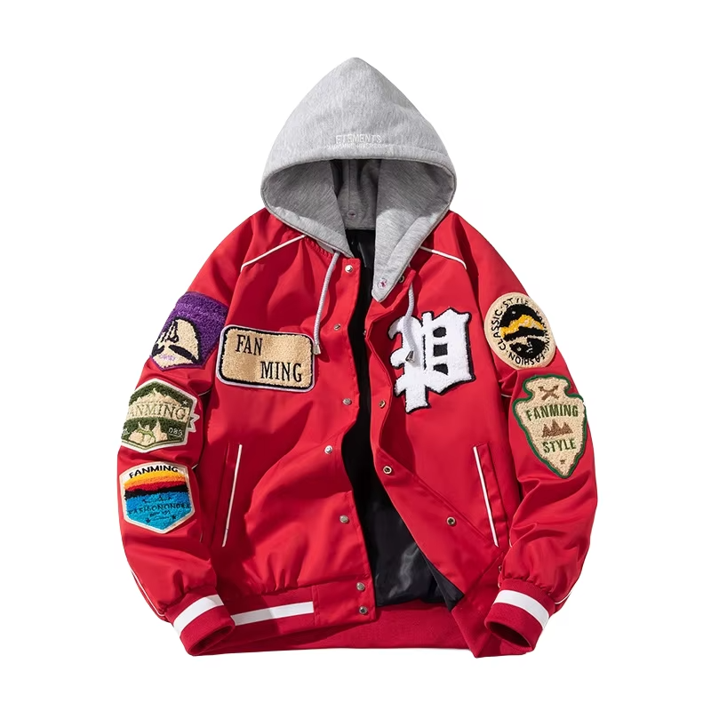 A detailed view of a custom badge varsity jacket featuring multiple high-definition chenille badges, wool body, and genuine leather sleeves