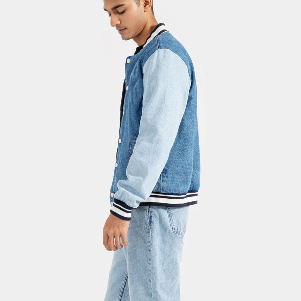 A detailed view of a custom denim varsity jacket featuring a high-quality washed denim body, contrasting sleeves, and custom chenille embroidery.