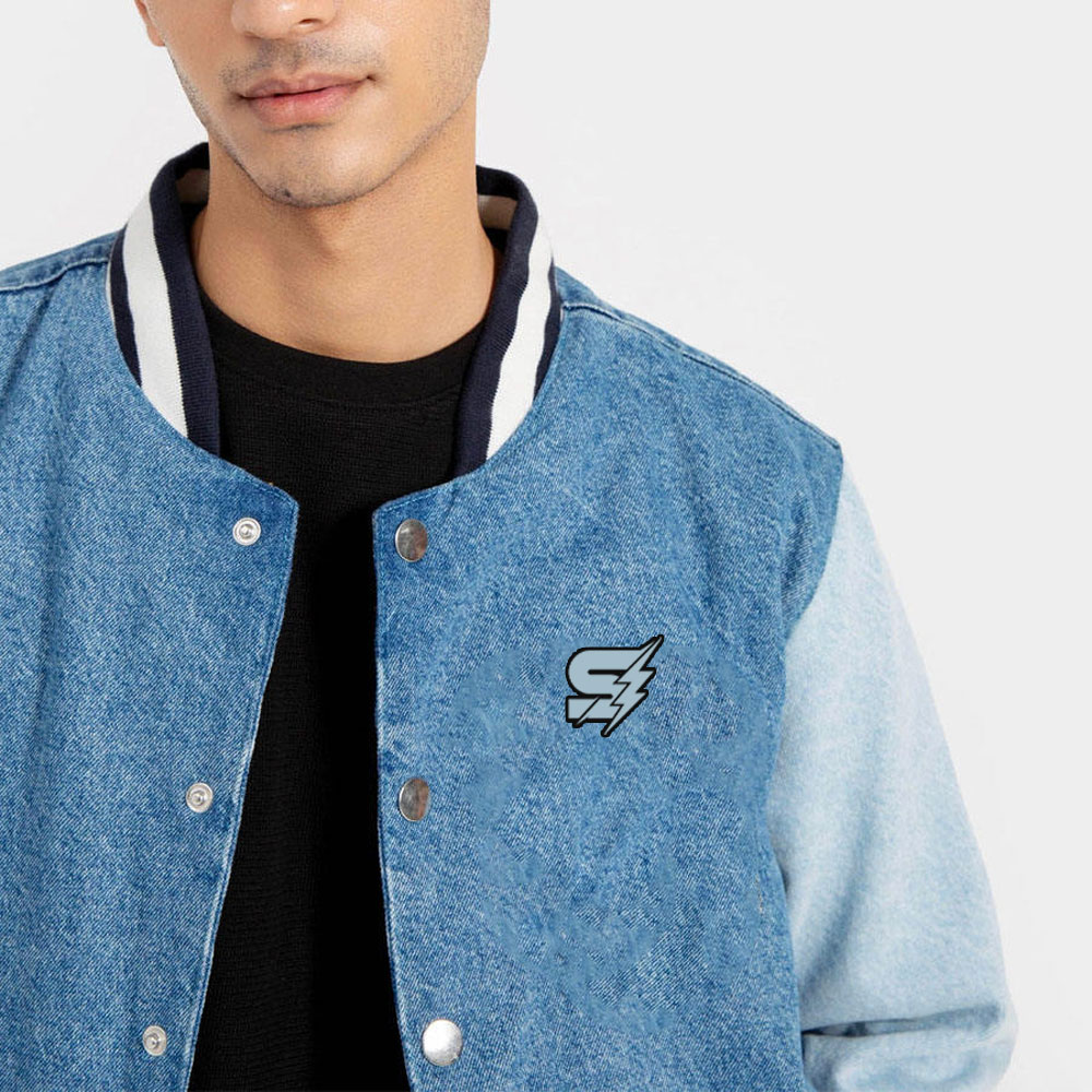 A detailed view of a custom denim varsity jacket featuring a high-quality washed denim body, contrasting sleeves, and custom chenille embroidery.