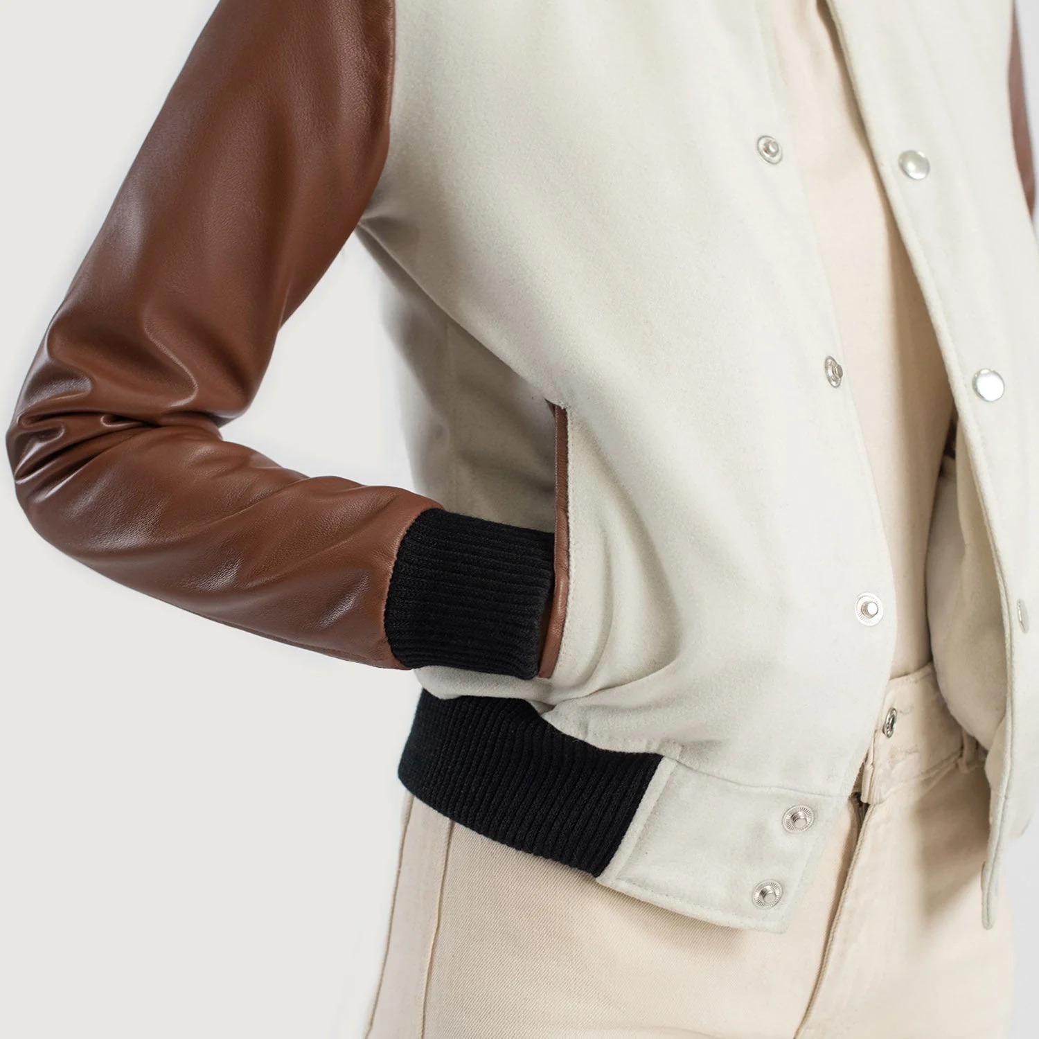 A detailed view of a custom leather varsity jacket women's featuring a tailored fit, butter-soft sheepskin leather sleeves, and premium wool body.