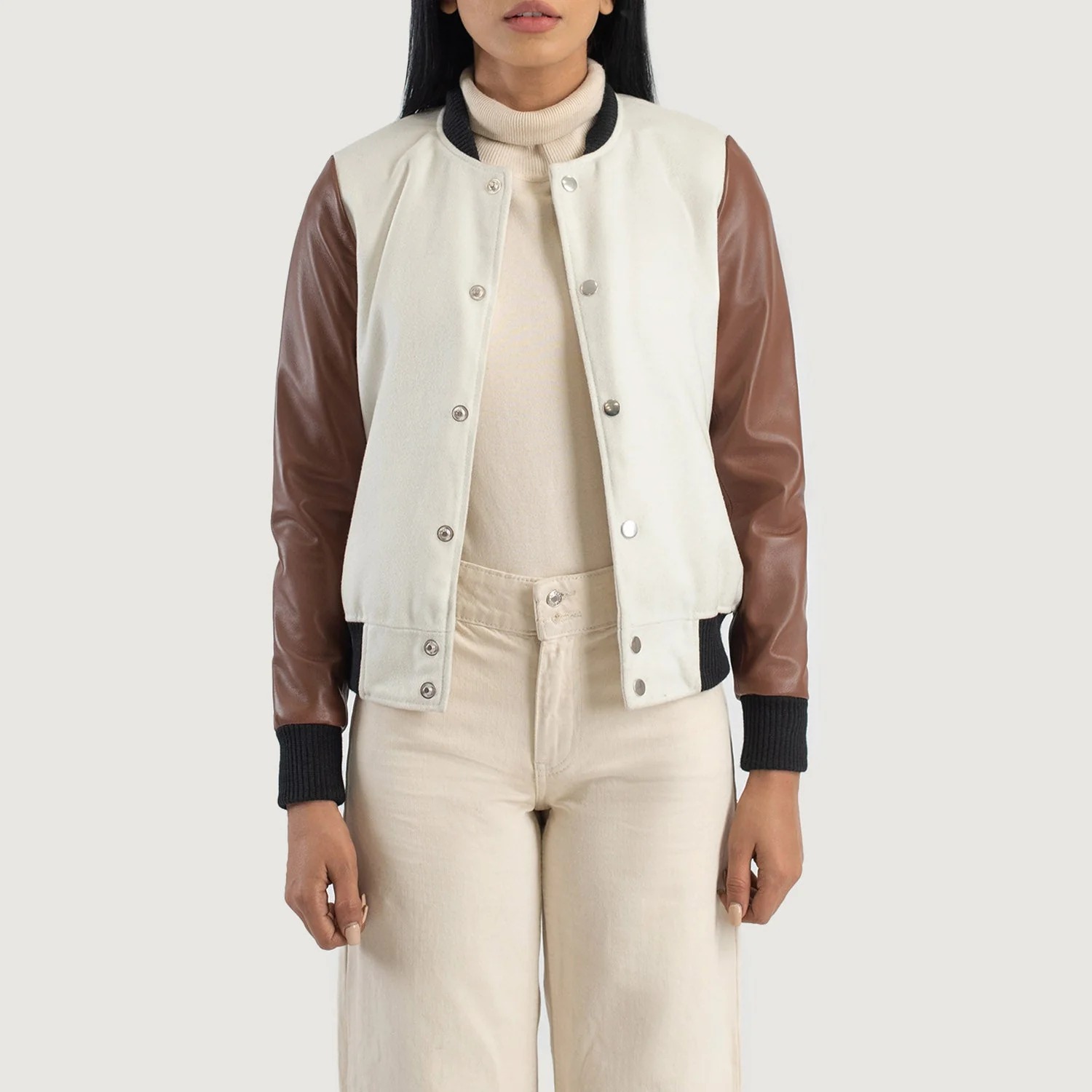 Text: A detailed view of a custom leather varsity jacket women's featuring a tailored fit, butter-soft sheepskin leather sleeves, and premium wool body.