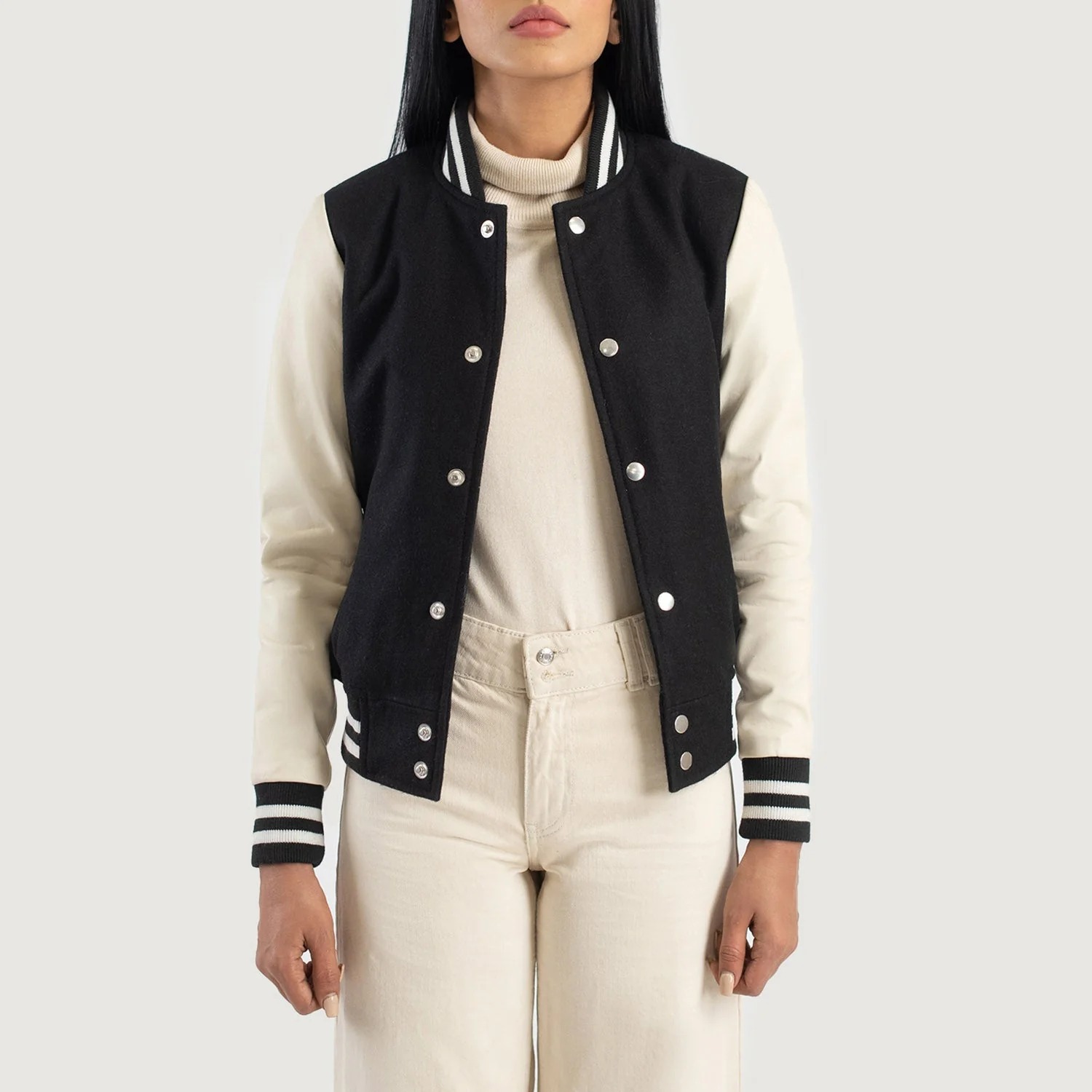 A detailed view of a custom leather varsity jacket women's featuring a tailored fit, butter-soft sheepskin leather sleeves, and premium wool body.