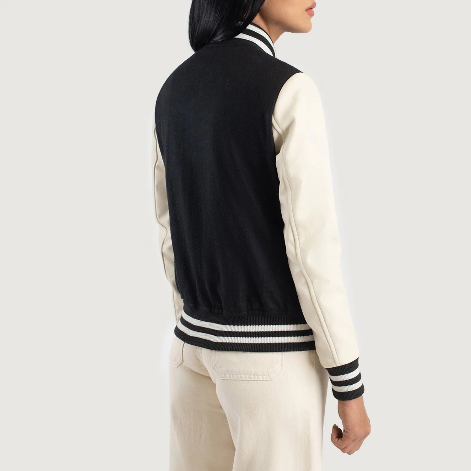 A detailed view of a custom leather varsity jacket women's featuring a tailored fit, butter-soft sheepskin leather sleeves, and premium wool body.