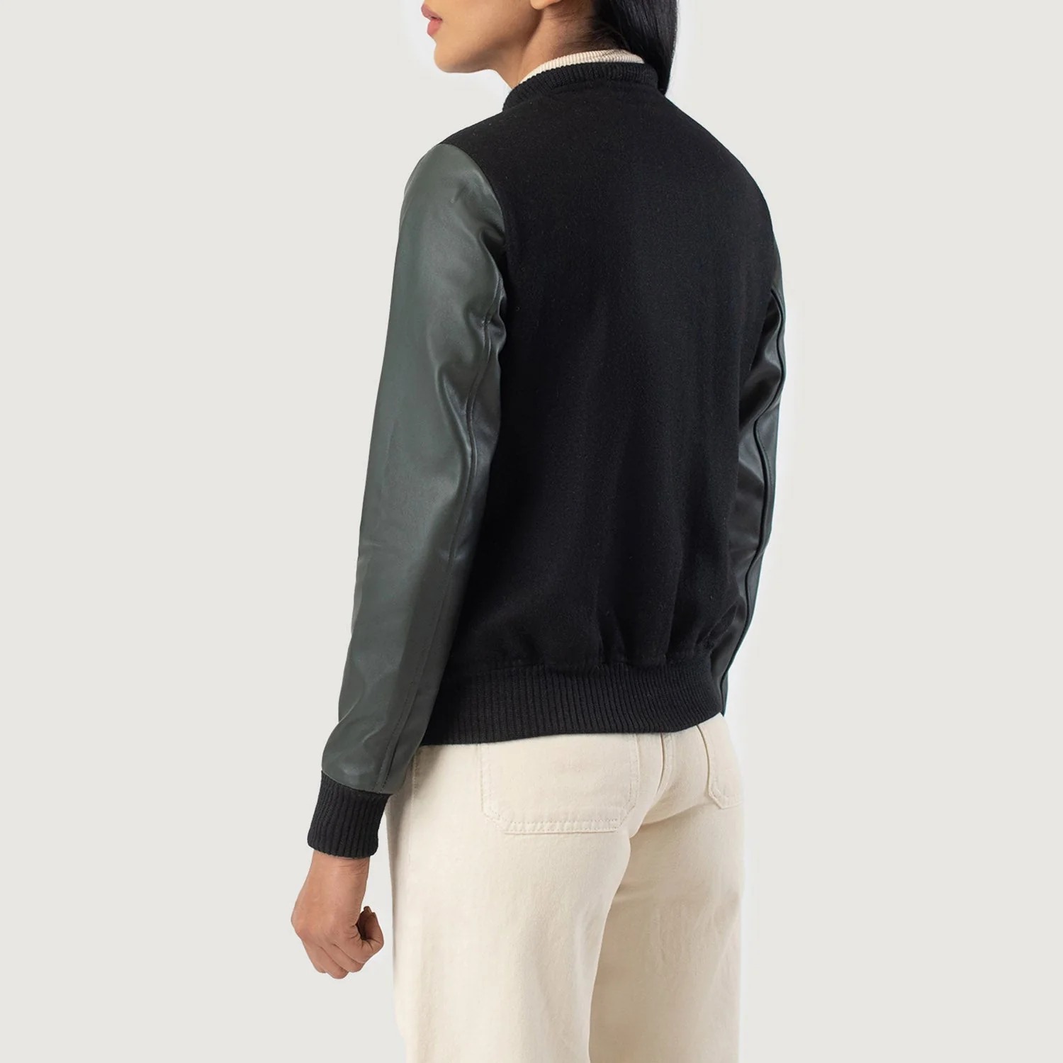 A detailed view of a custom leather varsity jacket women's featuring a tailored fit, butter-soft sheepskin leather sleeves, and premium wool body.