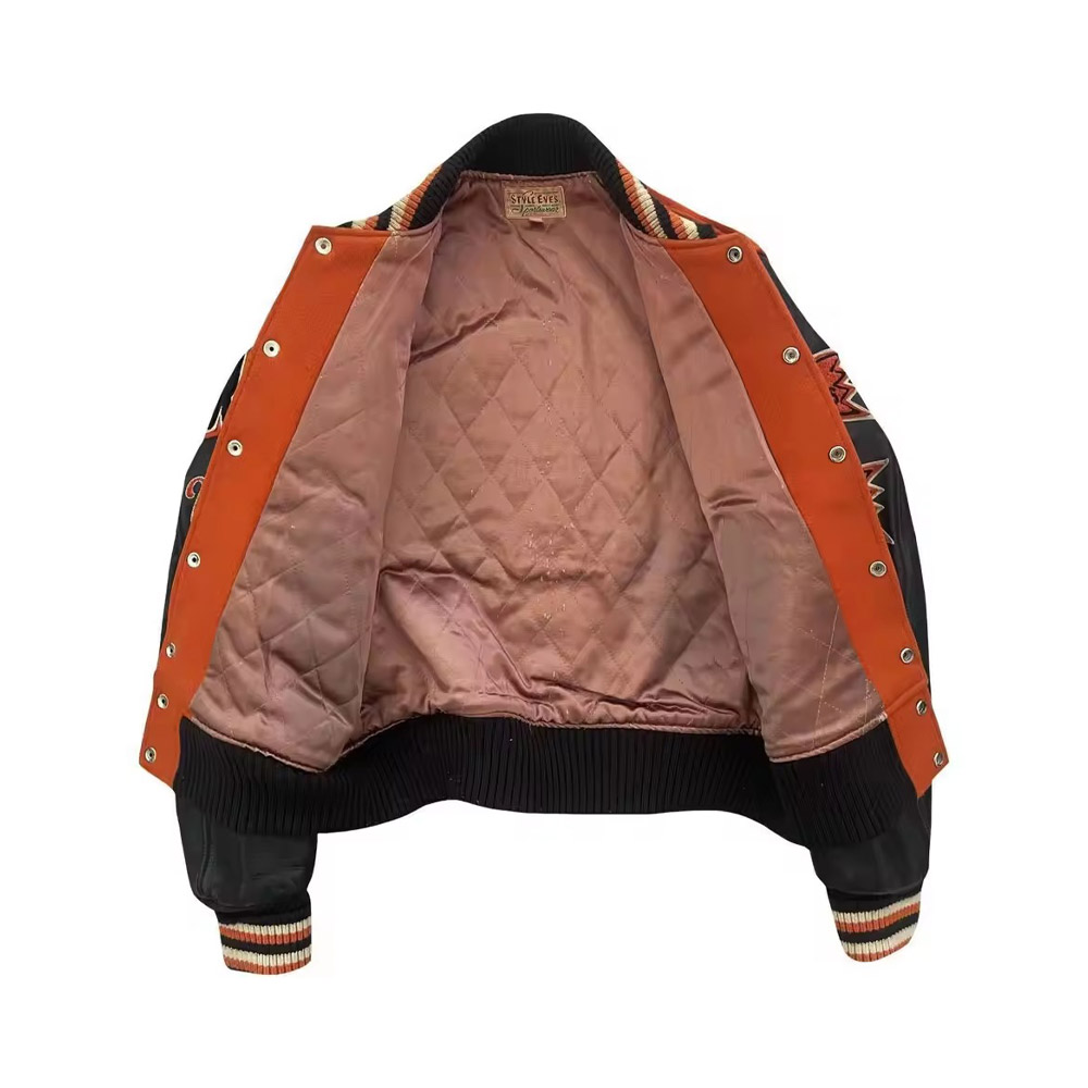 A detailed view of a premium custom-sports-team-varsity-jacket- featuring a high-quality wool body, genuine leather sleeves, and a custom-embroidered team mascot on the back.