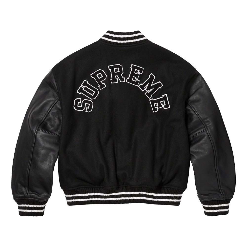 A detailed view of a custom Supreme varsity jacket featuring a premium melton wool body, genuine cowhide leather sleeves, and high-density chenille branding.