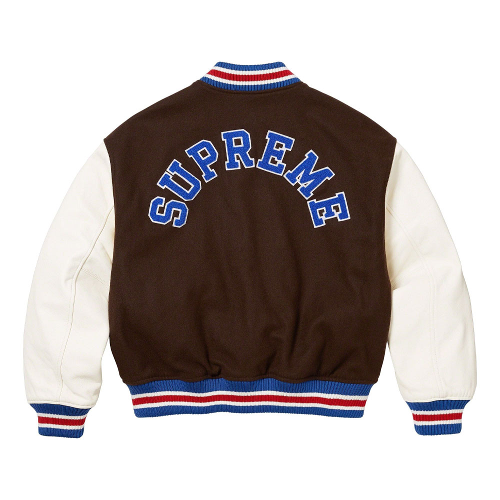 A detailed view of a custom Supreme varsity jacket featuring a premium melton wool body, genuine cowhide leather sleeves, and high-density chenille branding.